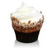 Moist spice cake infused with pineapples, bananas and pecans topped with cream cheese frosting and pecans